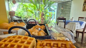A breakfast buffet with waffles, bread, and pastries. - Pousadar Marahú (Ipojuca)