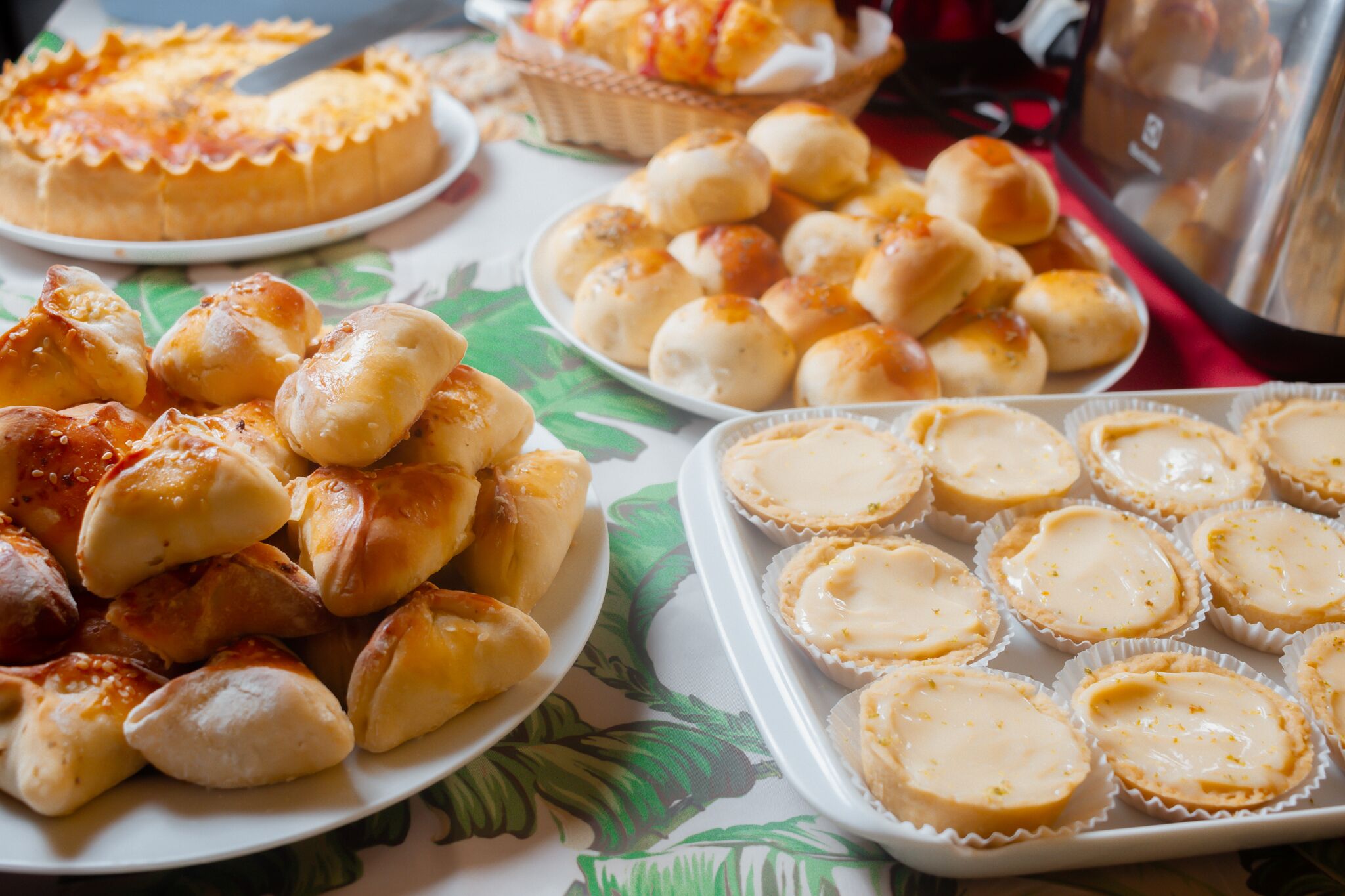A table with various baked goods including pastries and tarts.