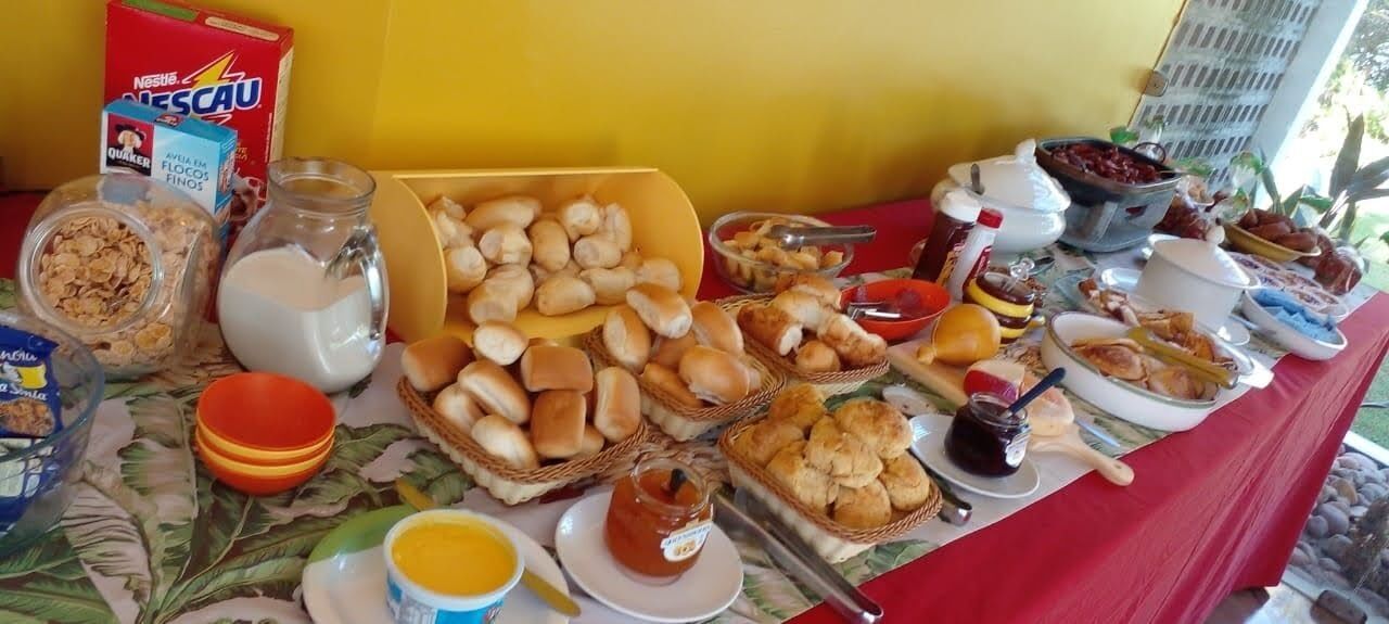 A buffet table with various food items, including bread, pastries, and condiments.