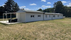 A single-story building with a covered patio area and a small attached garage.