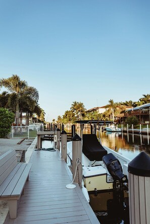 A marina with a wooden dock, boats, and palm trees. - Royal Harbor (34102) mins to 5th Ave shopping & fine restaurants - 1st Fl #2 (Naples)
