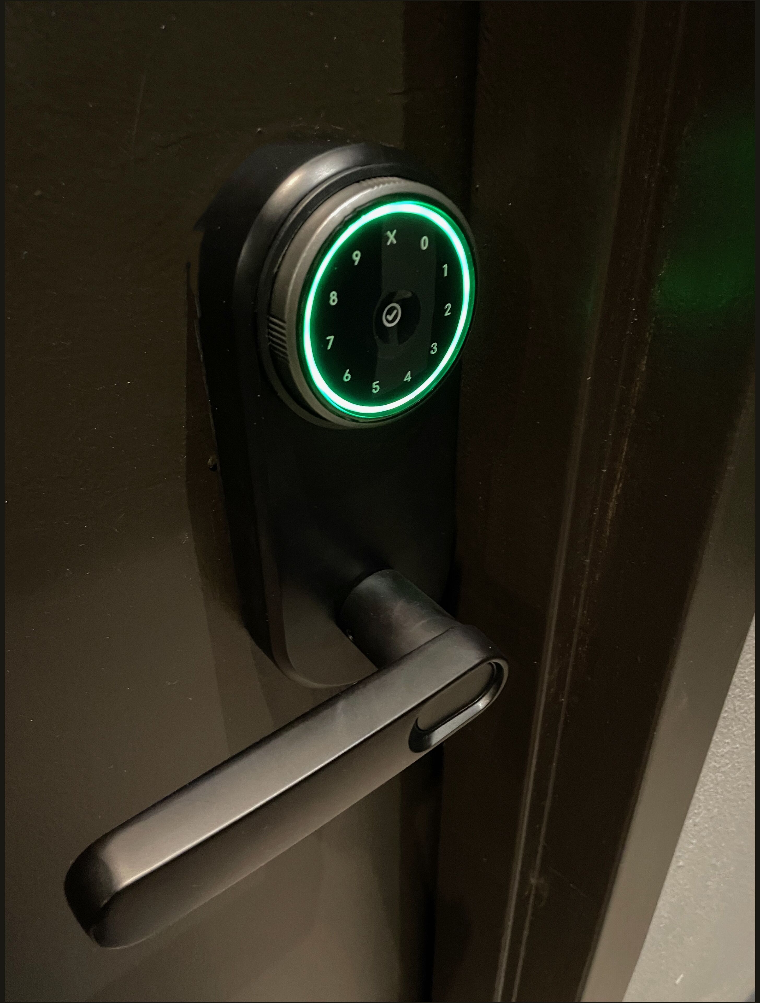 A modern door lock with a numeric keypad and a keyhole.