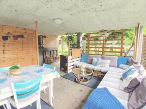 An outdoor seating area with a table, chairs, and a sofa.