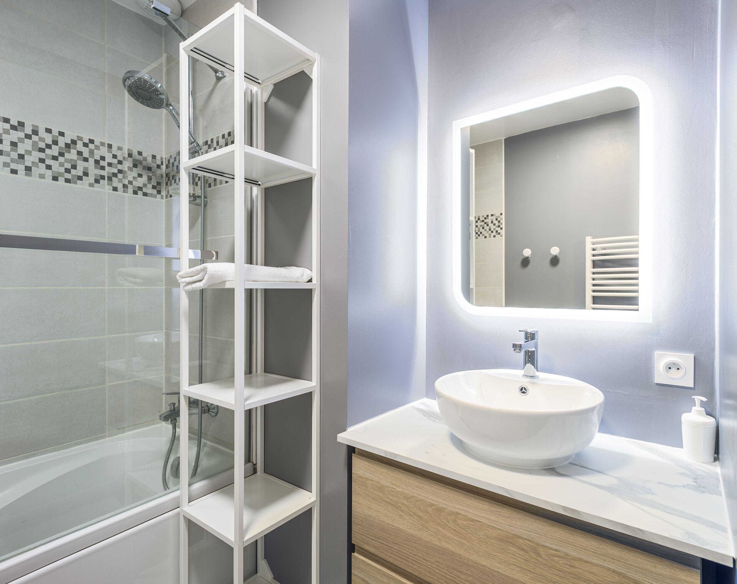 Bathtub, hair dryer, towels, toilet paper