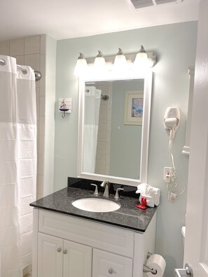 Bathtub, hair dryer, towels, soap