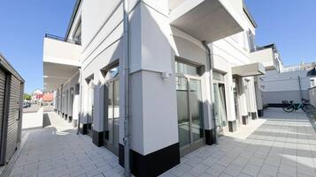 A modern building with a clean, white facade and large windows.