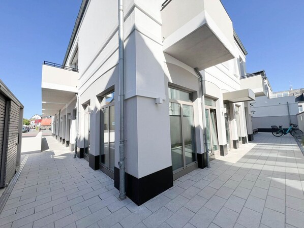 A modern building with a clean, white facade and large windows.