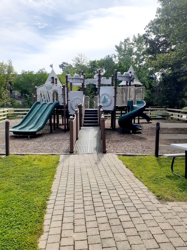 A playground with slides and a castle-themed play structure. - REST IN THE FOREST RECENTLY REMODELED VILLA WALKING DISTANCE FROM STARVED ROCK (North Utica)