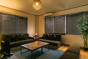 Relax in this stylish living room with two sofas, a coffee table, and a potted plant.
