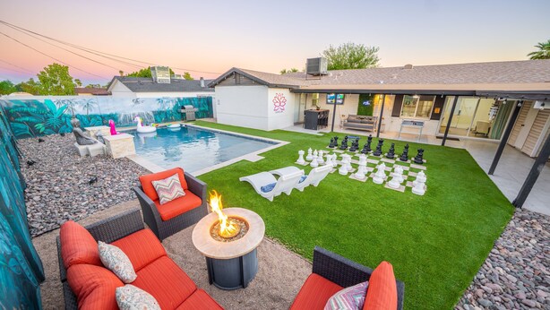 A backyard with a pool, outdoor seating, and a chessboard. - Zen home with heated swimming pool+ Billiards table+ arcade games (Scottsdale)