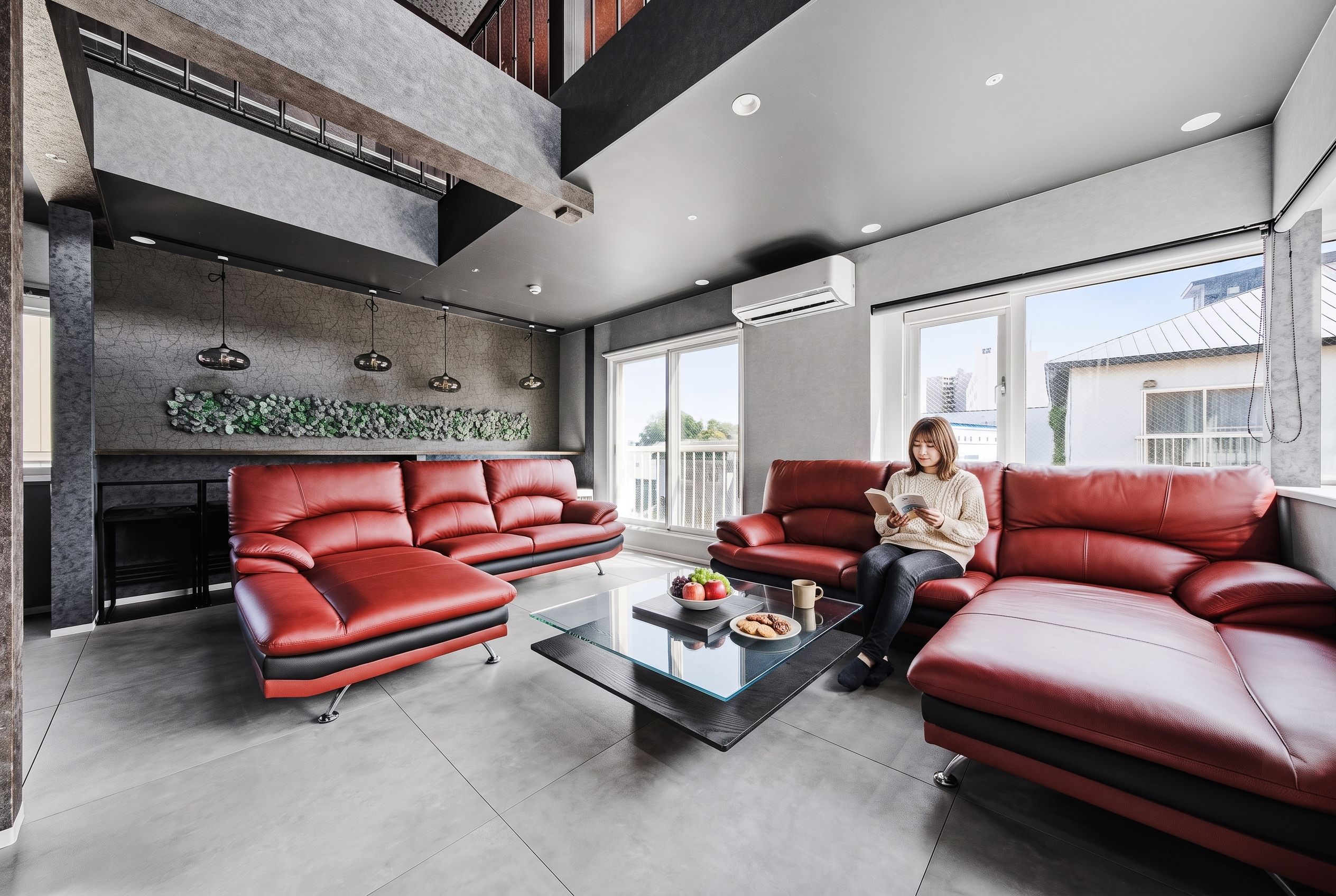 A modern living room with a red leather sofa set, a glass coffee table, and a fireplace.