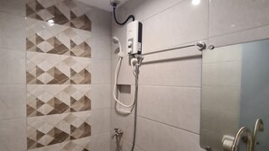 A modern bathroom with a shower, toilet, and sink. - My Stay Hotel - Near SM Mall - 1 min walk (Butuan)