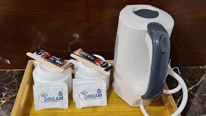 A tray with a coffee maker, two packets of instant coffee, and two branded coffee cups. - My Stay Hotel - Near SM Mall - 1 min walk (Butuan)