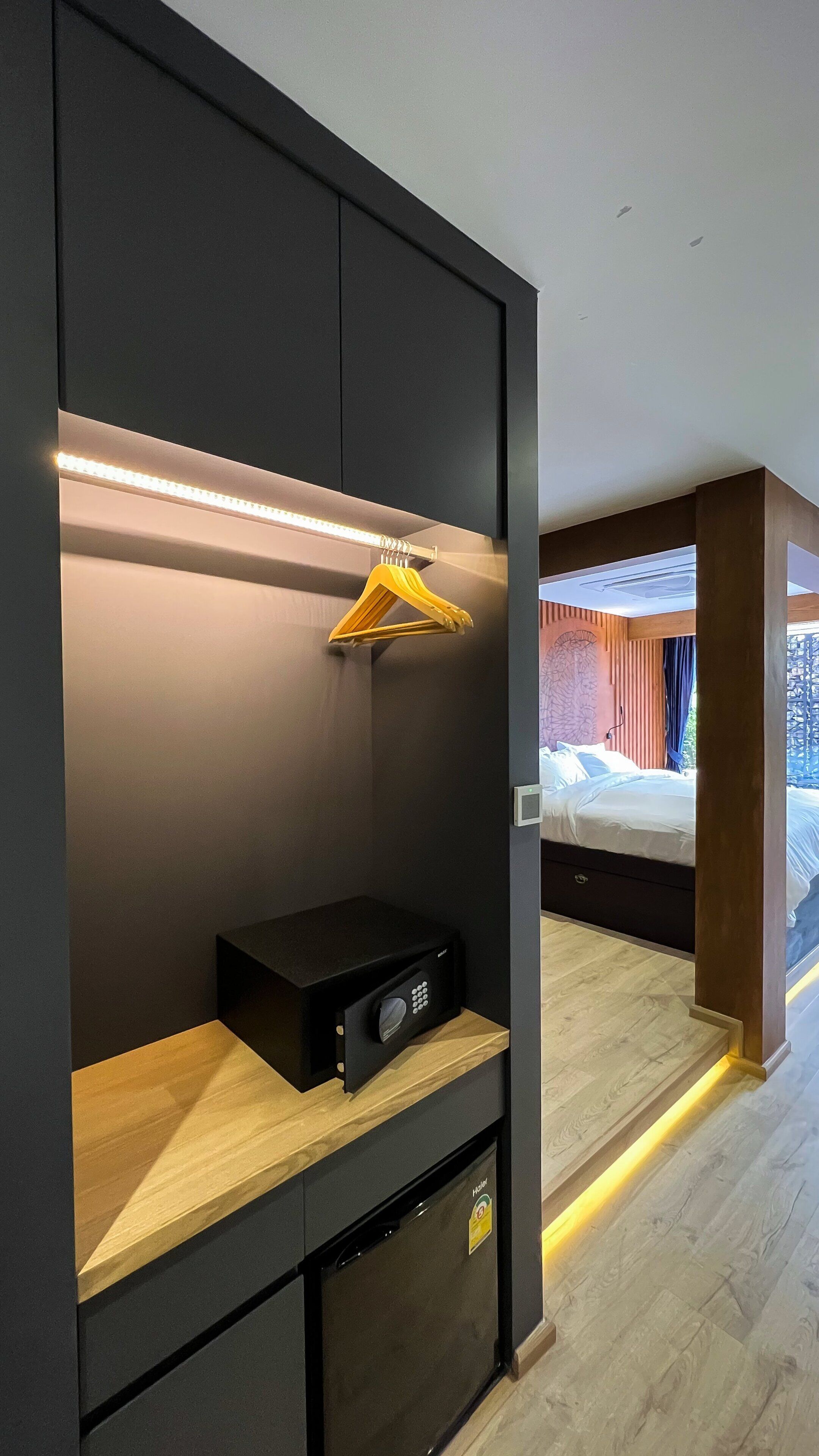 A modern bedroom with a built-in wardrobe, a bedside table, and a bed.