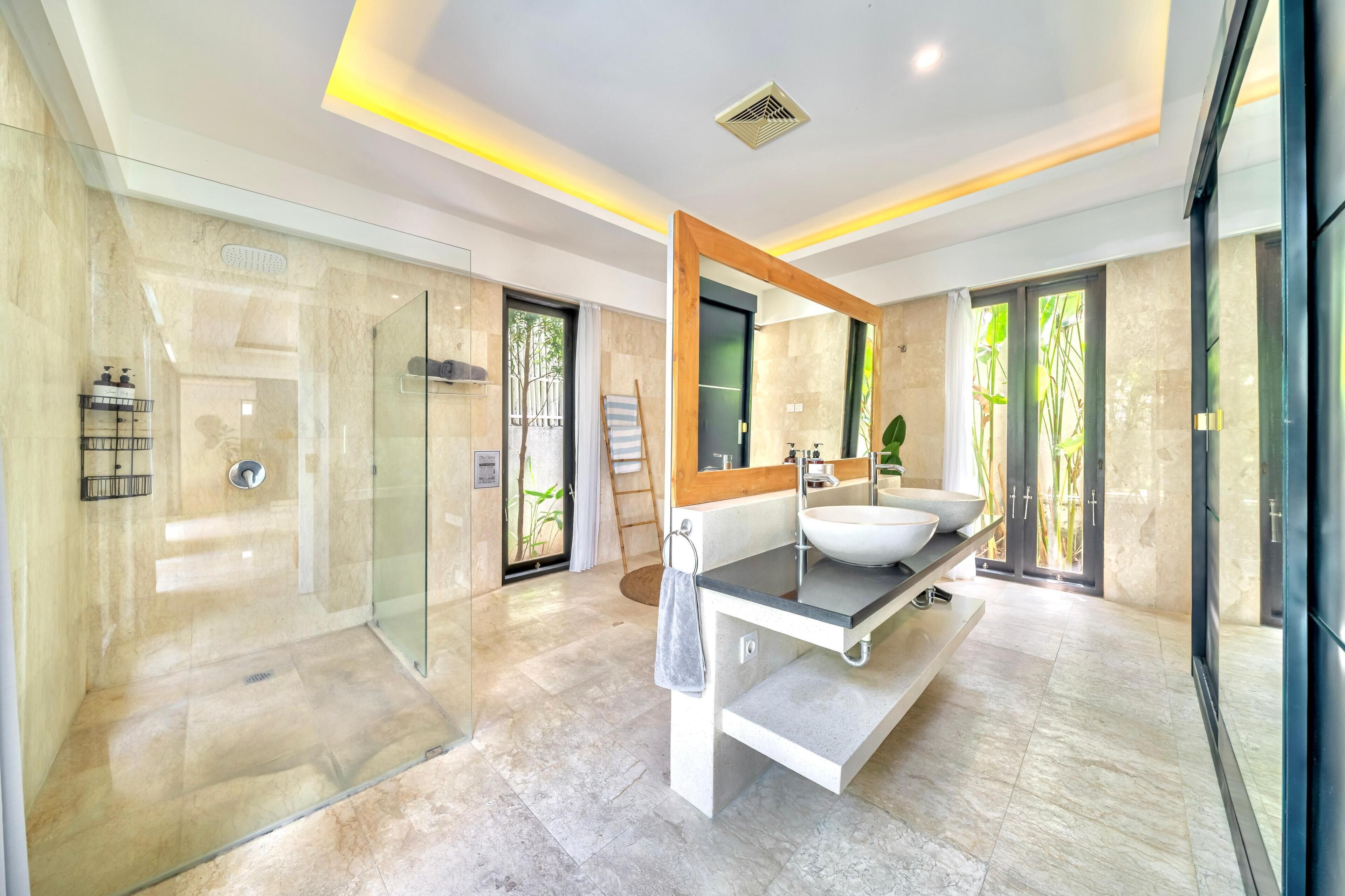 Bathtub, hair dryer, towels, toilet paper