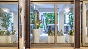 Interior moderno com portas de vidro deslizantes que dão para um pátio externo.