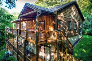 Relax on the spacious deck, surrounded by lush greenery, and enjoy the serene atmosphere.