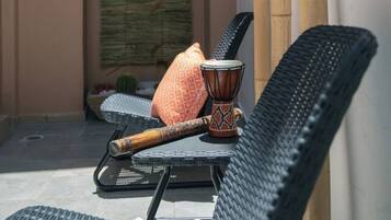 A seating area with a chair, a table, and a decorative item.