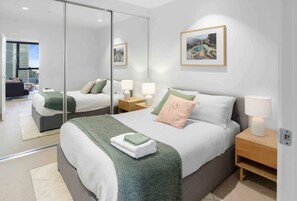 Enjoy a comfortable stay in this stylish room with a large bed, bedside table, and city view.