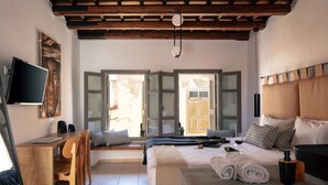 Ein Schlafzimmer mit Bett, Schreibtisch und Fernseher.