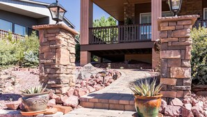 A house with a stone entrance, a covered porch, and a mailbox labeled "1156". - 3BR w deck, treetop views, dog friendly (Pine)