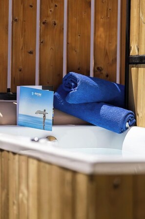 A wooden wall with a towel and a brochure on a white surface.