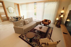 Economy Room, Patio, Pool View | Living area | 85-inch LCD TV with cable channels, TV - Aseel Resort  (Riyadh)