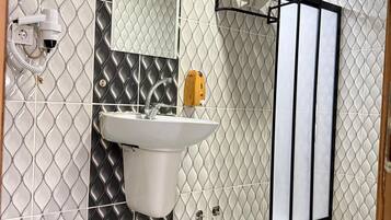Shower, hair dryer, slippers, towels