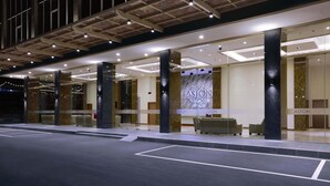A modern hotel entrance with a prominent sign reading "ASTON NAGOYA".