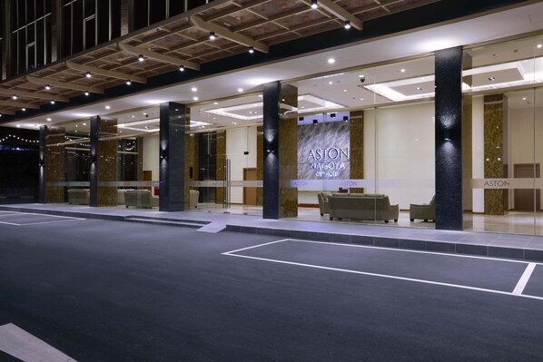 A modern hotel entrance with a prominent sign reading "ASTON NAGOYA".