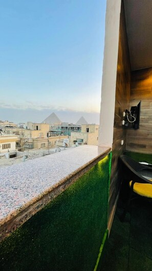 A balcony with a view of pyramids and a cityscape. -  Pyramids View Guest House (Giza)