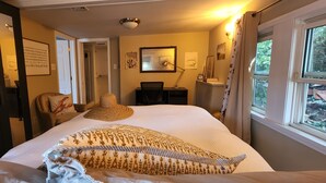 A bedroom with a large bed, a desk, a chair, and a window with curtains. - Beach, marina, restaurants! 1 bedroom, living room, bath with private entrance! (Wareham)