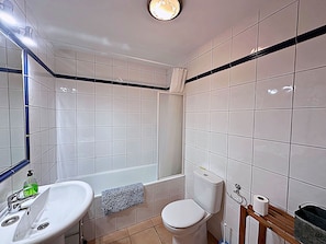 Bathtub, hair dryer, towels, soap