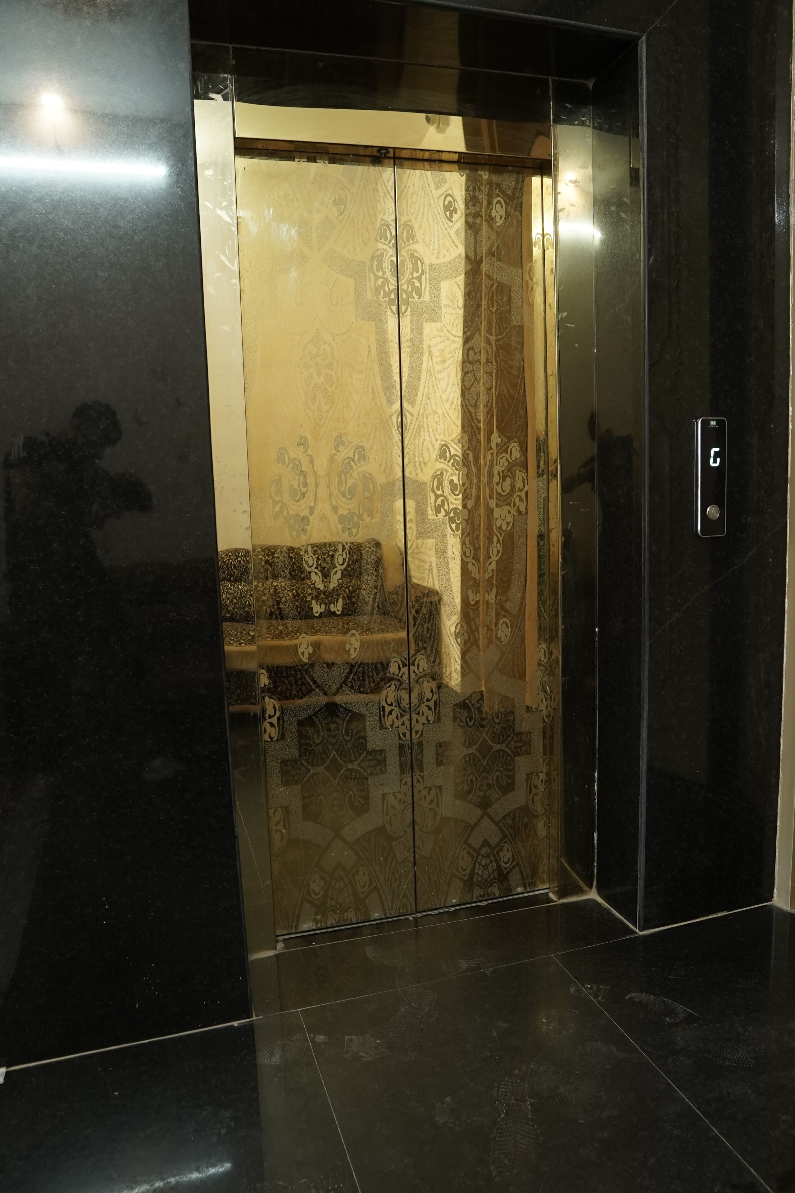 An elevator with a patterned interior and a control panel.
