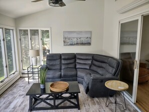 Relax in this stylish living room with a large L-shaped sofa, coffee table, and framed artwork.