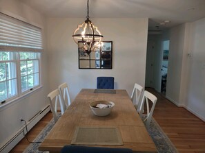 Enjoy meals in this stylish dining area with a wooden table and comfortable seating for four.
