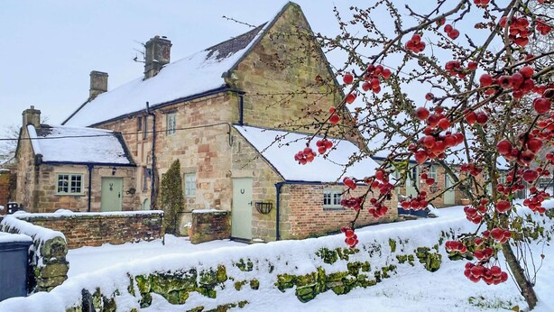 A stone building with a sloped roof, surrounded by snow. - Jasmine Cottage - UK4176 (Middle Mayfield, near Ashbourne)