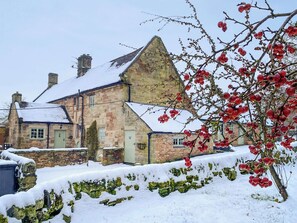 A stone building with a sloped roof, surrounded by snow. - Jasmine Cottage - UK4176 (Middle Mayfield, near Ashbourne)