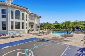 A residential property with a swimming pool, outdoor seating, and a basketball court. - Lavish 8 Br Estate with Pool & Courts (Plantation)