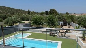 A rooftop pool with a clear view of the surrounding landscape, including trees and a distant hill. - CASA DEL SOL, LUXURY AND RELAX BY THE SEA (Peñíscola)