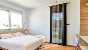 A bedroom with a bed, a desk, and a window. - CASA DEL SOL, LUXURY AND RELAX BY THE SEA (Peñíscola)