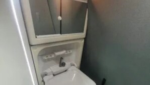 A small bathroom with a white sink and mirror. - Camper 8 “Bertha” (Leinster)