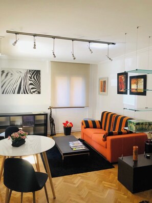 Relax in this stylish living room with a round dining table, sofa, and coffee table.