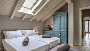 A bedroom with a large bed, a dresser, and a skylight. - Villa Sonni - Four Bedroom Villa, Sleeps 8 (Bellagio)