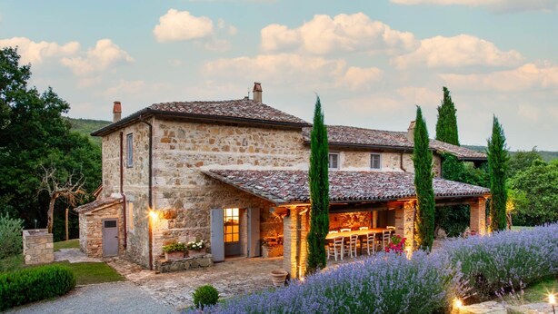 A stone house with a tiled roof, a covered outdoor dining area, and a garden with lavender. - Villa Tirelli - Five Bedroom Villa, Sleeps 10 (San Casciano dei Bagni)