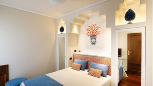 A bedroom with a bed, pillows, a nightstand, and a wall-mounted artwork. - Villa Minerva - Three Bedroom Villa, Sleeps 10 (Sant'Agnello)