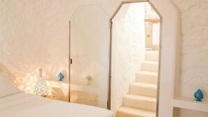 A bedroom with a large bed, a glass door leading to a staircase, and decorative items on the nightstands. - Villa Minni - Three Bedroom Villa, Sleeps 6 (Monacizzo-librari-truglione)