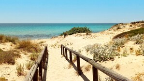 A sandy beach path leading to the ocean with a wooden fence. - Villa Minni - Three Bedroom Villa, Sleeps 6 (Monacizzo-librari-truglione)