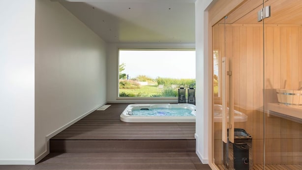 A modern bathroom with a hot tub, wooden flooring, and a view of a garden. - Villa Suprema - Four Bedroom Villa, Sleeps 8 (Pirato)