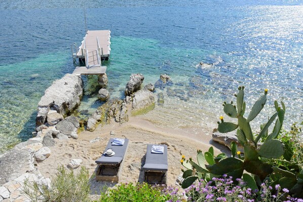 On the beach, sun-loungers